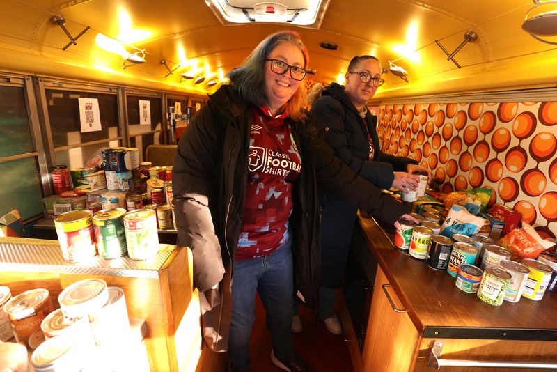 Burnley fans delivering donations to the American-style school bus