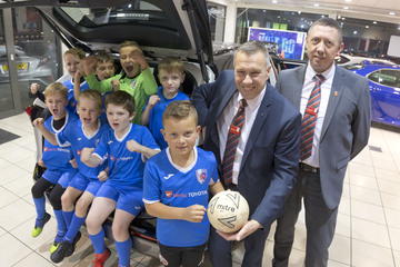 David Littlewood (second from right) and Matthew Parks (right) of Toyota Chesterfield with members of the Brampton Rovers U8s team
