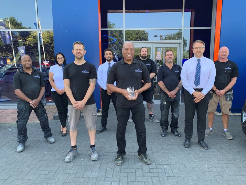 Pictured from left to right: Winston Forbes (Bodyshop Technician) with colleagues, Sam Oliver , Tom Howe, Chris Godsell, Winston Richards, Jon Hodges, Anthony Howe, Trevor Franklin, Nigel Legg.