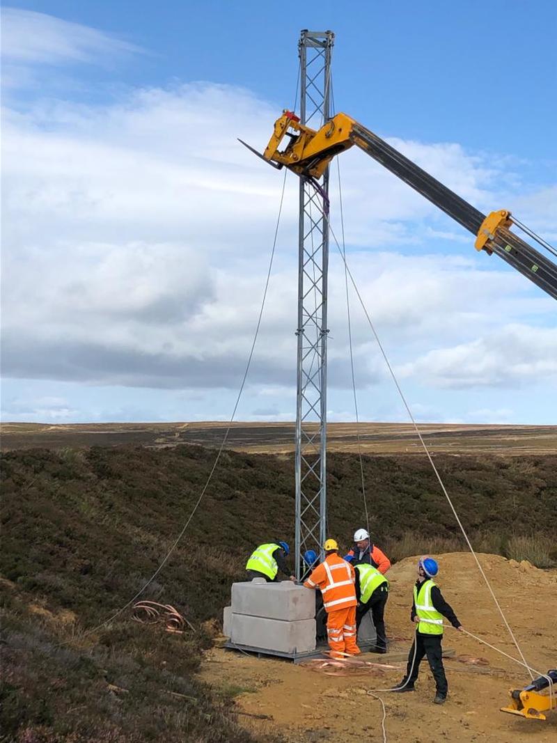 The first 10 metre section of mast being lifted into place on 23 Sept