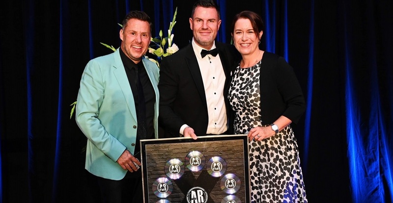 Ben Quaintrell (centre) accepts an award from compere Aaron James and Sally Lawson, CEO and founder of Agent Rainmaker at the awards ceremony
