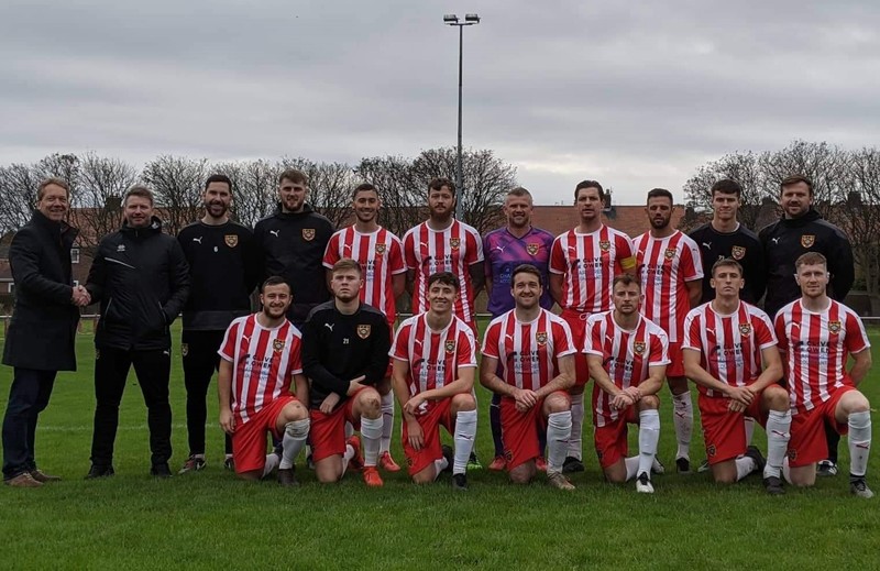 Gary Ellis (far left) and Gary Pearson – the manager of Ryhope FC with Ryhope Colliery Welfare FC players showing off the kit