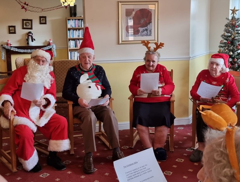 Residents (and Santa) practicing their carols