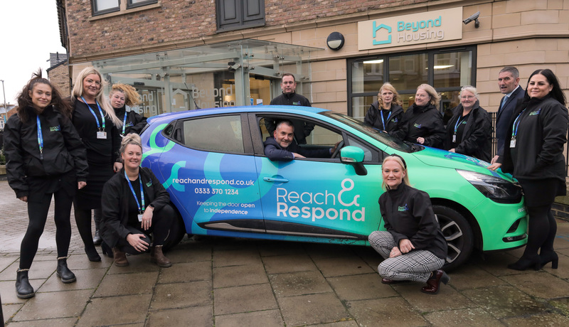Jason Lowe, Beyond Housing Head of Independent and Supported Living (in car) celebrates the Scarborough launch of Reach and Respond with colleagues.