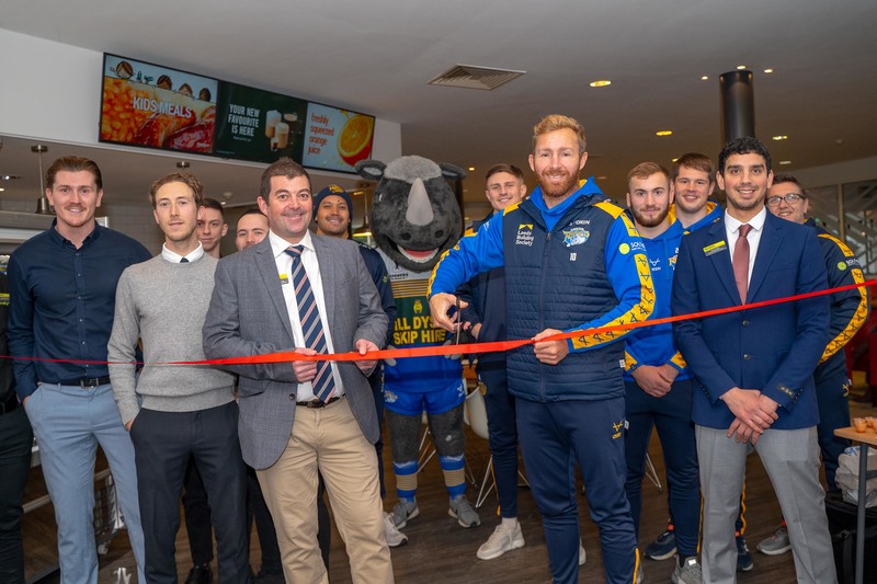 Colin MacGillivray (Bannatyne Group), Matt Prior (Leeds Rhinos) and Craig Smith (Bannatyne Group) joined by members and staff at the café bar opening 