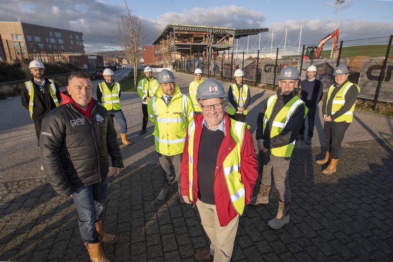 Richard Caborn, former Sports Minister and Sheffield Central MP (front, centre) joins key stakeholders to celebrate the latest construction milestone at Sheffield Olympic Legacy Park Community Stadium