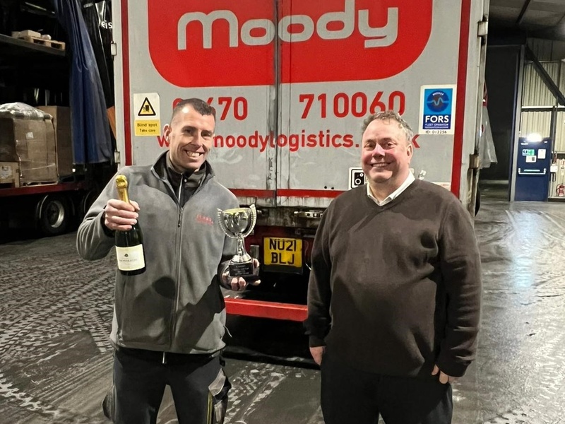 Michael Crackett (left) receives his Driver of the Year award from operations director, Richard Moody