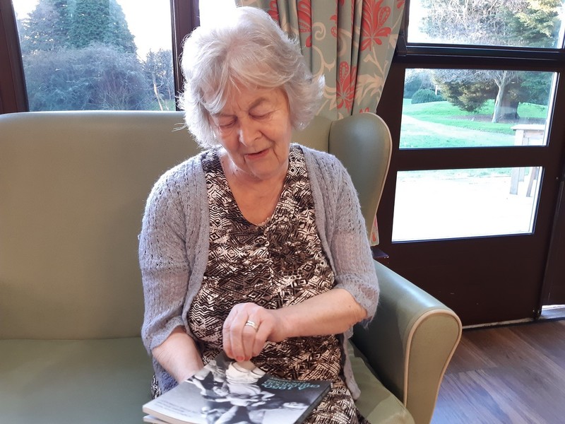 A resident reading a memory book