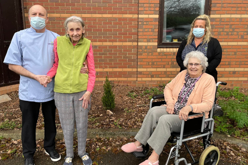 Oake Meadows residents and carers with the memorial to Bruce the cat 