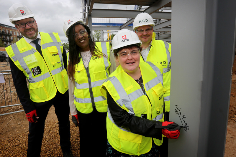 Orla Eves (front), resident of the existing ABI hospital in York, signs her name on the steel of the new hospital at the Chocolate Works. Back left to right, Andrew Hurcomb, GMI Construction Group, Irene Sobowale, CEO, Disabilities Trust and Tom Wheldon f