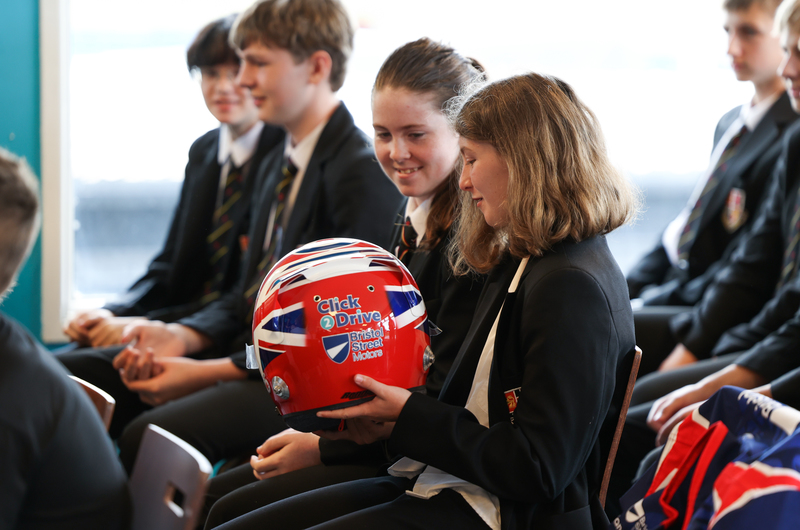 Pupils looking at Click2Drive Bristol Street Motors professional helmet