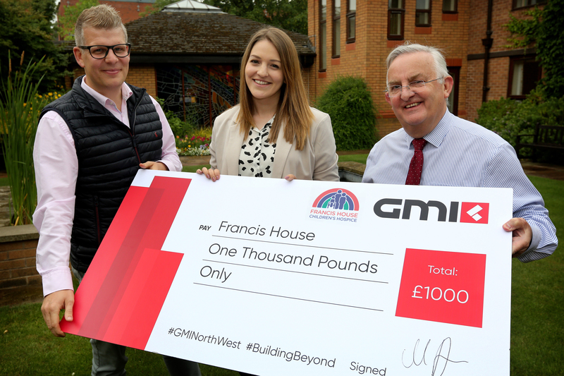 L-R Marc Banks, GMI’s divisional managing director donating £1,000 to Rachel Nasiri and David Ireland of Francis House.