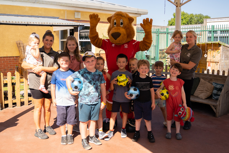 Roary the Lion with children from Rosedene
