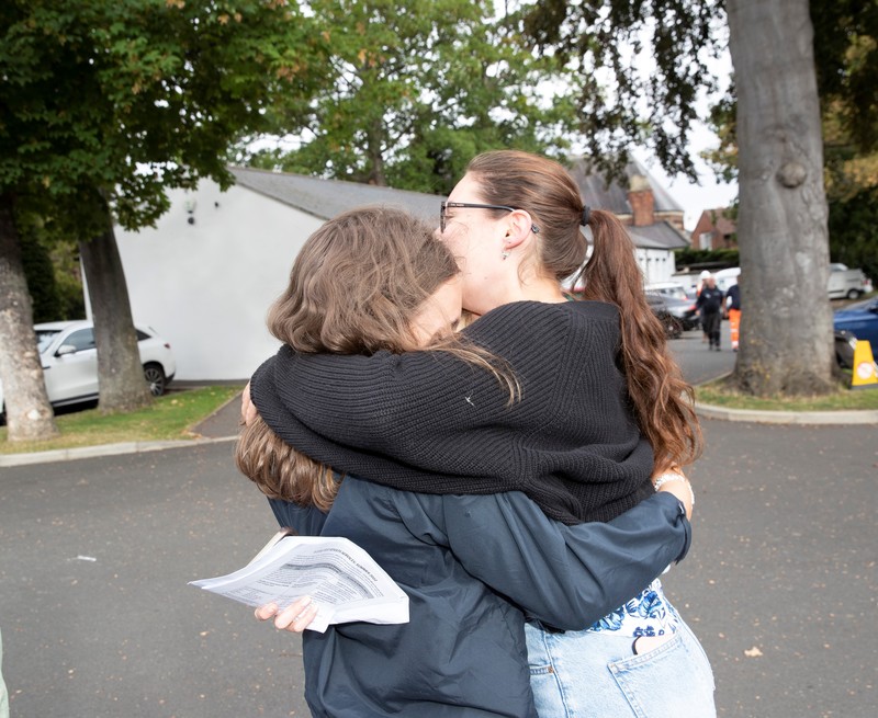 Madeleine Lane and Emily Carter hugging