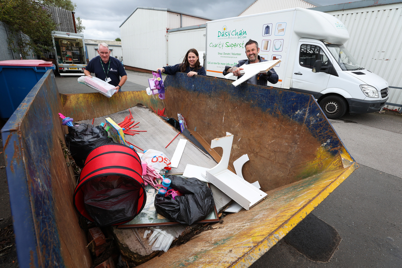 Martin Shuttleworth, Mia Scott, and David Scott Jr help load a skip with items damaged during the break-in at Daisy Chain’s charity superstore