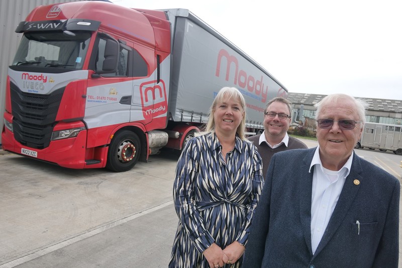 L-R:  Caroline Moody with operations director Richard Moody and chairman Alan Moody next to one of the new Iveco S-Ways that bear the 75th anniversary logo 