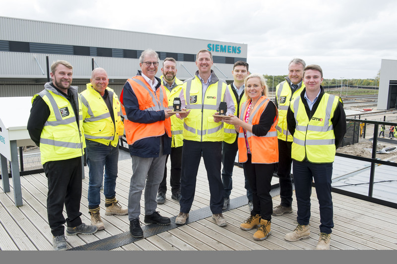 Members of GMI Construction team receive its awards from Siemens Mobility on the site in Goole