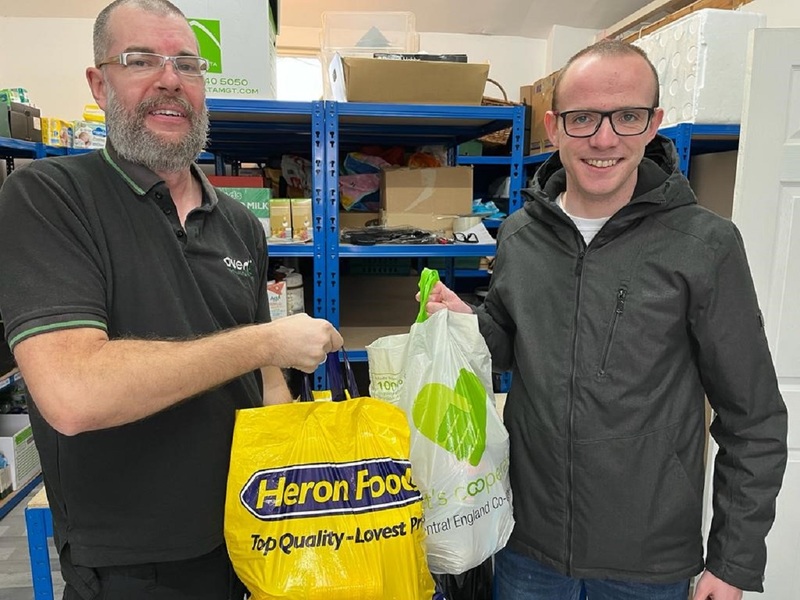  L-R: Elliott Robinson hands over donated foodstuffs to Stephen Palmer at Community Essentials in Solihull