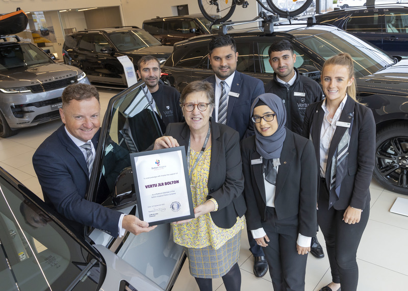 Dealership colleagues left to right    James Boyd  Darren Hunter Jai Aujla  Nisbah Begum  Jawad Rawat Emily Owens With Dr Leigh Vallance, chief executive of Bolton Hospice