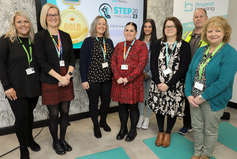 Rachel Docherty, Beyond Housing HR Partner and Lead Health Advocate (front, left) and  Catherine Clennett (front, right), Beyond Housing Director of People, celebrate the Better Health at Work Gold Award with some of the other Wellbeing Advocates.