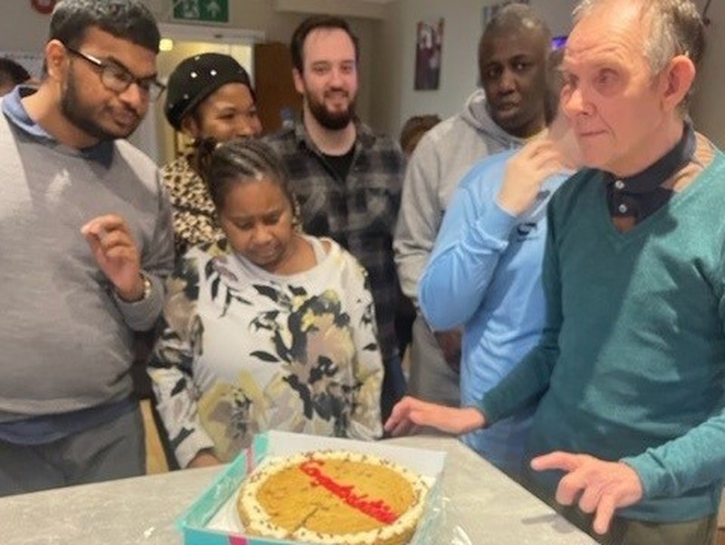 Staff pictured with a cake celebrating the result of the inspection 