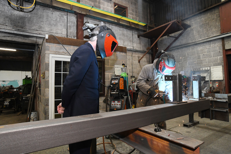 Jacob Rees-Mogg MP observing some welding 