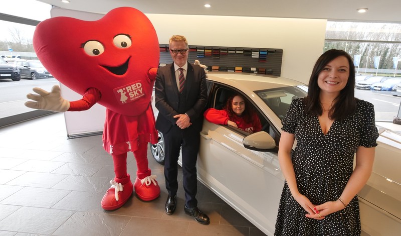 Red Sky Foundation's mascot Miss Beats with Vertu Motors CEO Robert Forrester, Caitlyn the new owner of the Volkswagen, and Carly Sells, Director at Charity Escapes