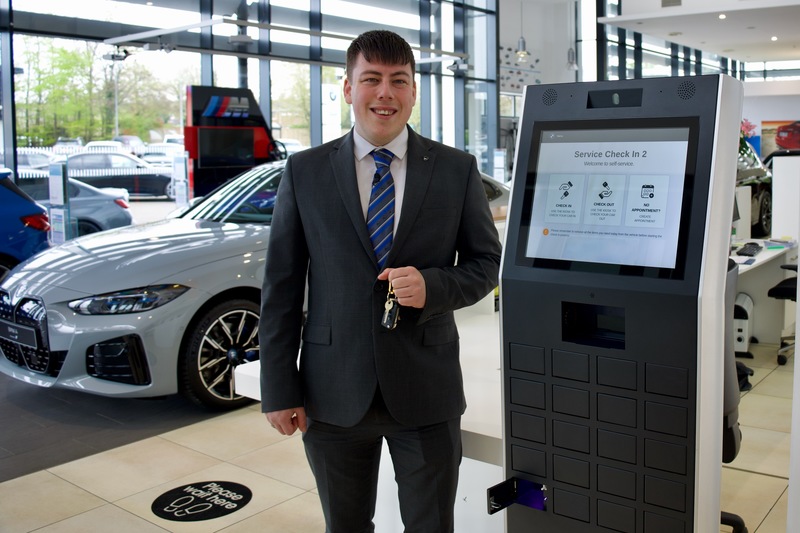 Luke Sinclair - Field Marketing Manager with one of the Tjekvik kiosks