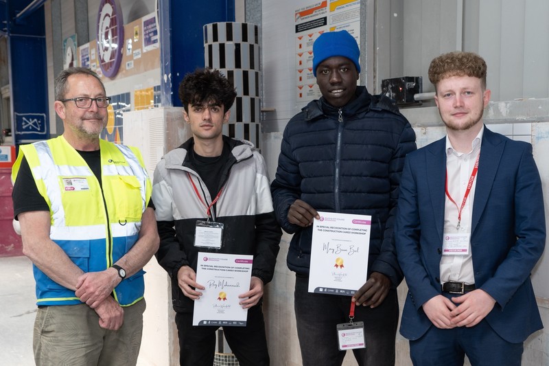 David Livesey (left) of South & City College and Nick Turner (right), Responsible Business Partner at GMI Construction Group, present certificates to Ranj Mohammadi and Maiy Buom Biel, two of the care leavers who attended the DIY skills programme