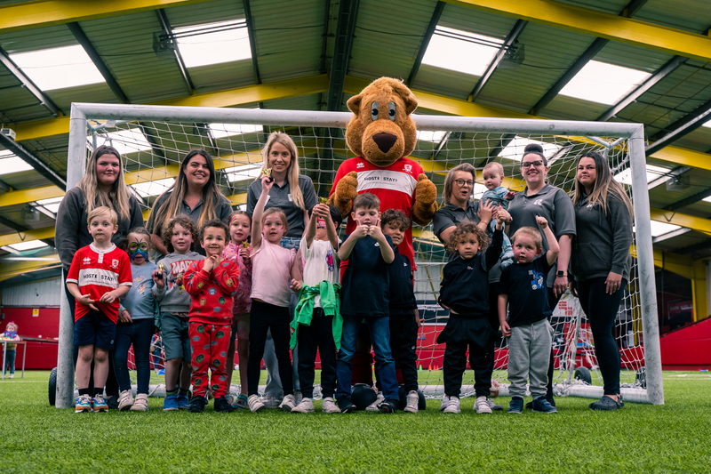 Roary the Lion with children and the team from Rosedene