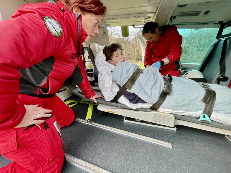 Jacob Honeyborne-Sharp in the helicopter with GNAAS paramedic Sarah Graham and Dr Antonia Hazlerigg