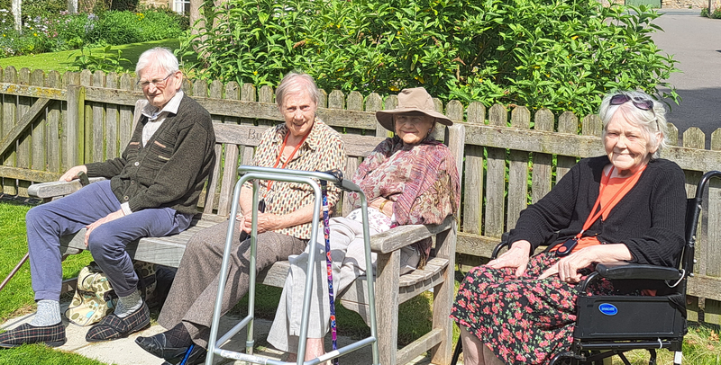 Residents enjoying the sunshine in the new garden 