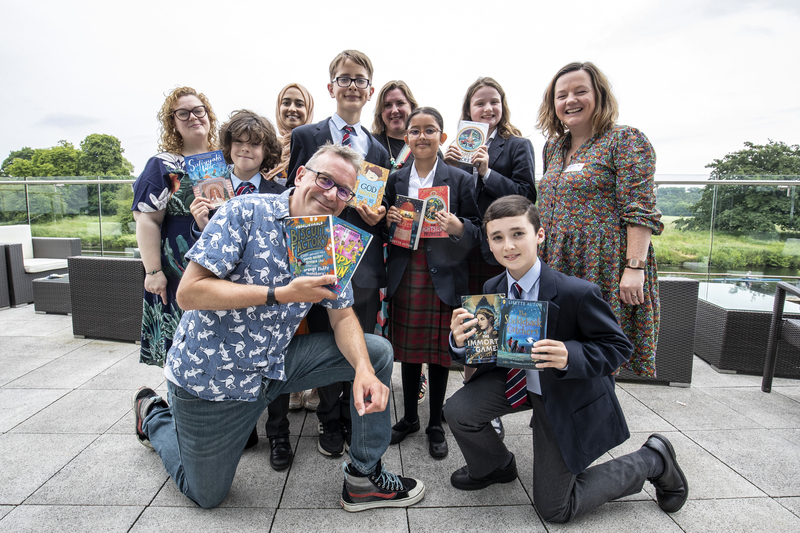  Authors Annaliese Avery (back left), Hiba Noor Khan, Bethany Walker, Lisette Auton, and James Harris (front) with pupils from Yarm School 