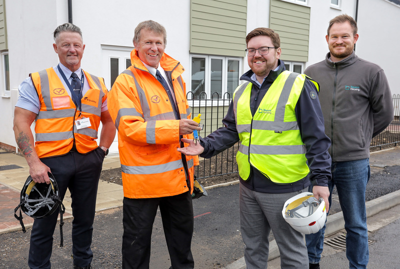Beyond Housing Project Manager Ben Briggs (3rd left) and Housing Officer Christopher Brown (right) take handover of the first two new build homes from Equans Operations Manager Alan McInroy (left) and Project Manager Graeme Dougherty (2nd left).