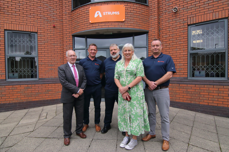 David Moore (left) with Amanda Solloway MP (middle) and the team at STRUMIS Ltd
