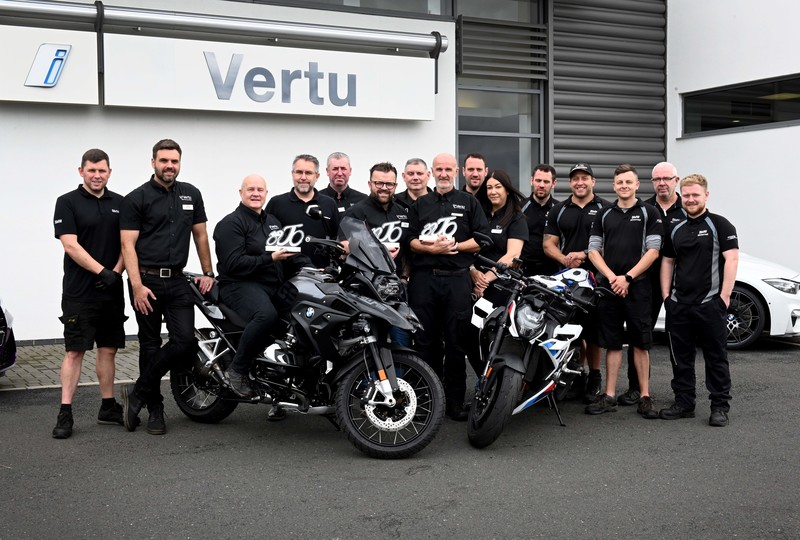 The dealership's general manager Mark Exley (sat on motorcycle) with BMW's Phil Thornton and the rest of the dealership team