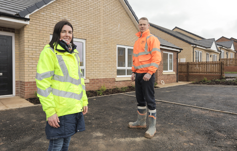 Beyond Housing Senior Project Manager Louise Bentley (left) and Esh Assistant Site Manager Dan Breslin (right) pictured outside recently completed homes at Hummersea Hills. 