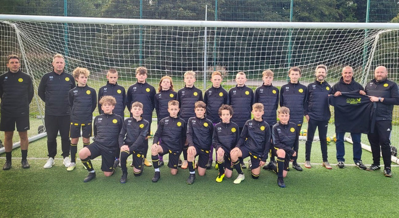Stonehaven Youth FC U14s sporting their new training tops with (from right) manager Adrian Hay and Ross Walker