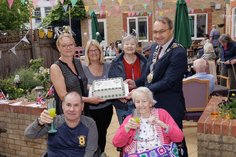 Residents and staff of Alexander Court celebrate the home's 25th anniversary with Cllr Stuart Wright, Mayor of Thetford