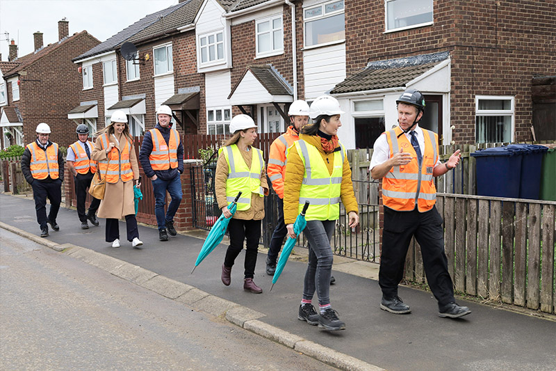 Equans Project Manager Graeme Dougherty (right) and Beyond Housing Regeneration Manager Sarah Hall (4th right) lead the tour.    