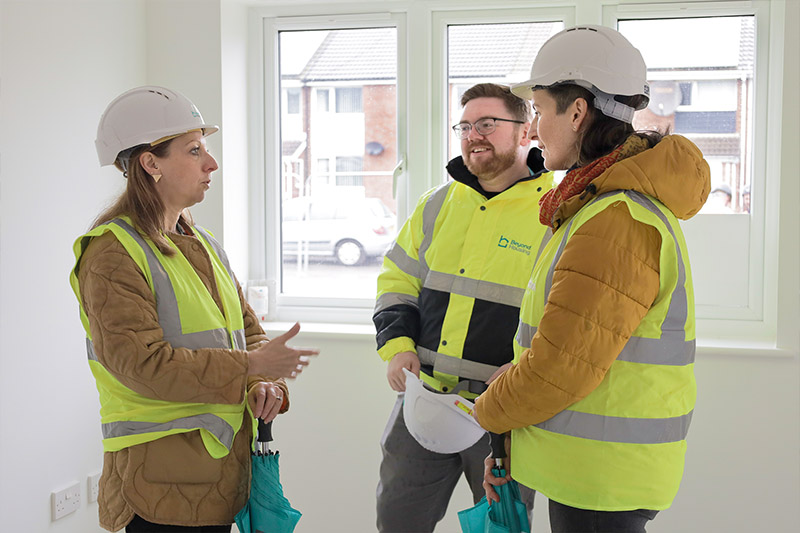 Beyond Housing Regeneration Manager Sarah Hall (left) and Project Manager Ben Briggs (centre) guide visitors around one of the new build homes. 