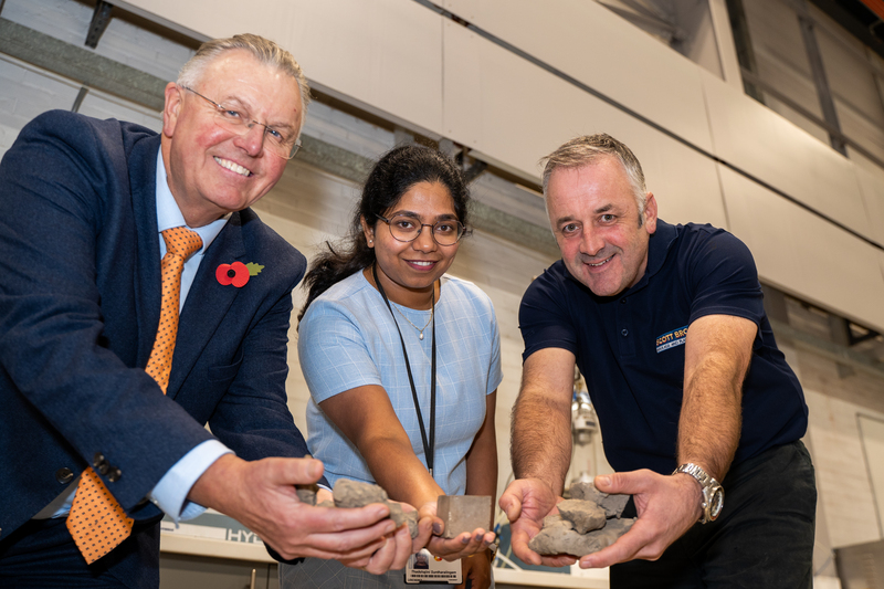 Scott Bros directors Bob Borthwick and Peter Scott with Structural Engineering Lecturer Dr Thadshajini Suntharalingam with samples of the waste clay that make up the prototype bricks  