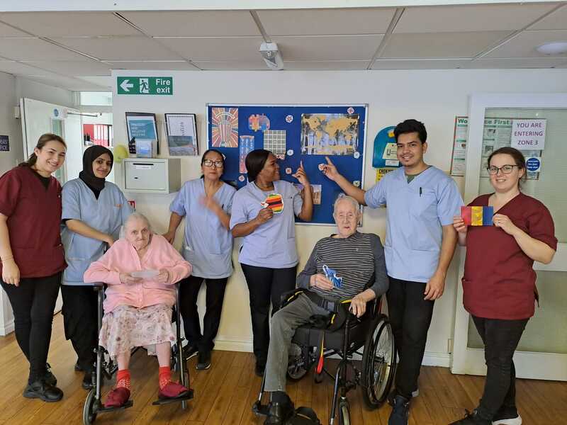 Residents and staff show off their world tour map 