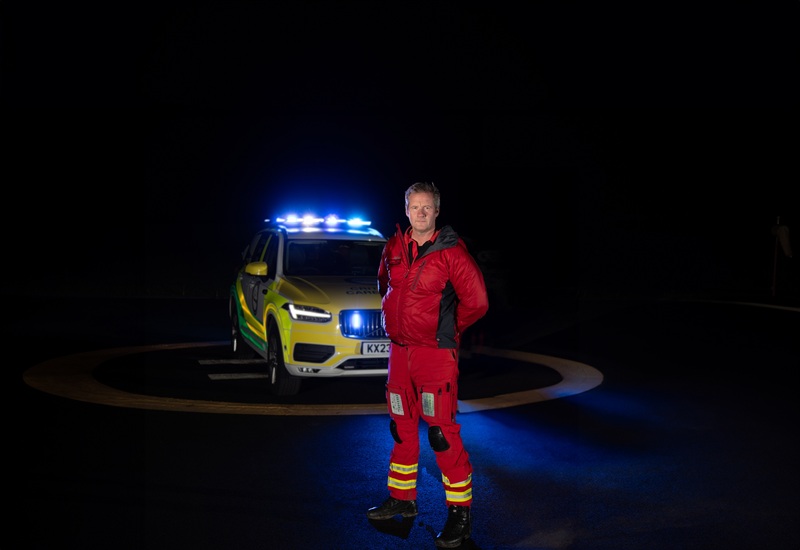 Dr Mike Davison in front of the rapid response car