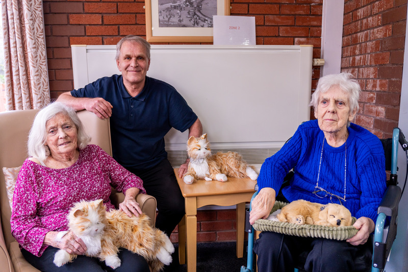 Riverside House residents Sheila Grey and Phyllis Gree, with the home's activities coordinator Richard Dobinson and Marmalade 