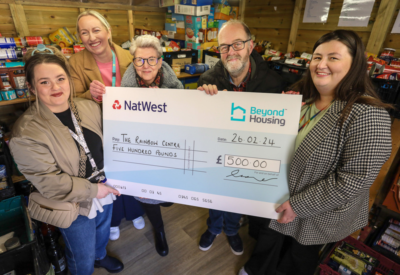 Beyond Housing colleagues (from left) Georgia Raines and Stephanie Lake present a cheque for £500  to (from 3rd left) Rainbow Centre CEO Jo Laking, Operations Manager Mike Lynskey, Customer  Support Manager Rose Randerson