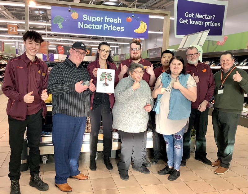 Residents visit staff at Sainsburys to present a Tree of Life