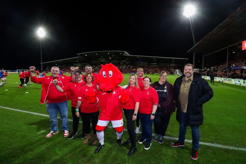 Members of Wrexham’s Fit Dragons programme attend the home tie with Port Vale