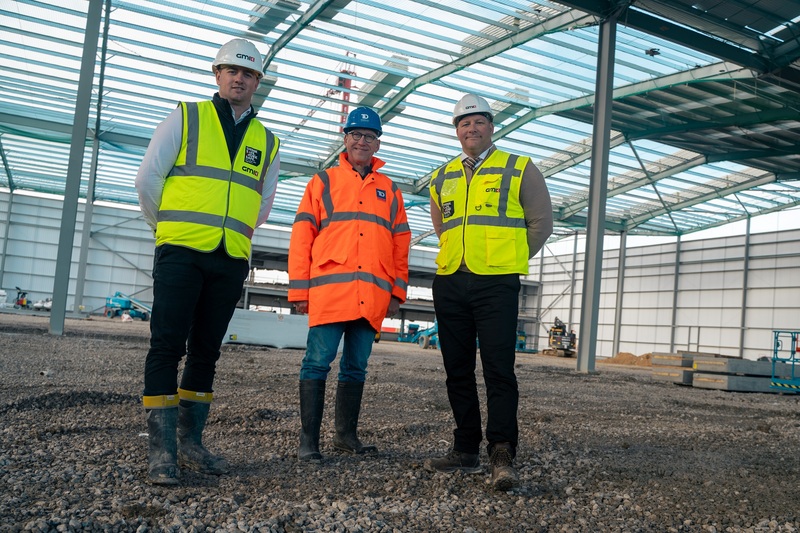 L-R: GMI Project Manager Dominic Dickinson with Bob Tattrie, Managing Partner of  Trebor Developments and Lee Powell, CEO of GMI Construction Group at the logistics centre being developed for Siemens Mobility